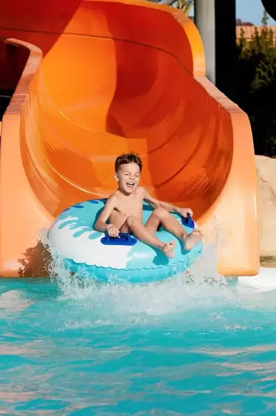 boy sliding down a waterslide