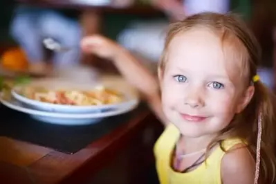 Portrait of adorable little girl having lunch