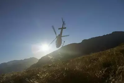 Helicopter going above mountain