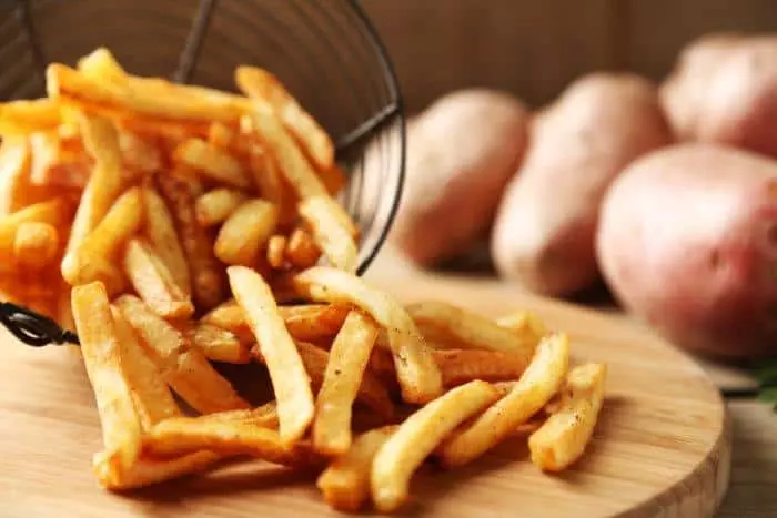 A basket overflowing with french fries.