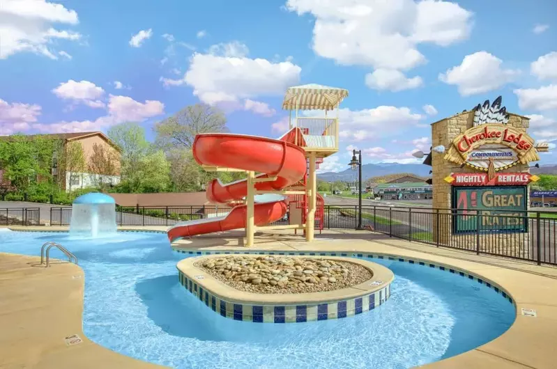 Outdoor pool with waterslide and water feature